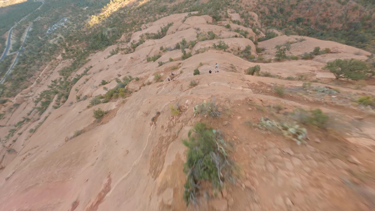 Fast close diving flight along steep rocky Mountain, Bell Rock , Sedona. FPV drone first point of view