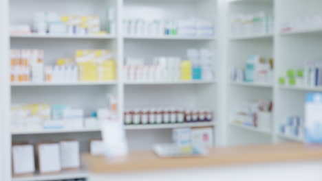 blurred view of stocked pharmacy shelves