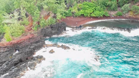 fly in overlooking the red sand beach on maui, hawaii