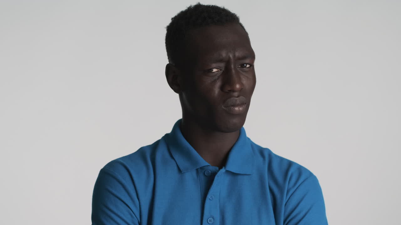Thoughtful African american man on grey background.