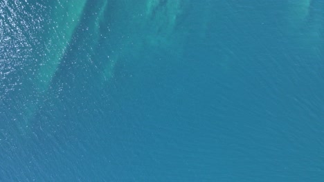 overhead 4k drone clip over a rock formation in the tropical blue waters of toroni in chalkidiki