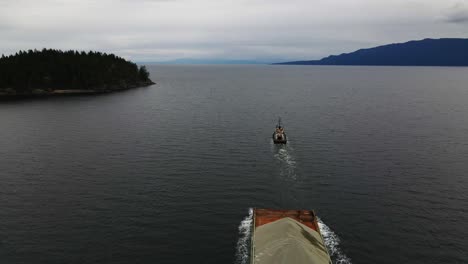 Aerial-shot-of-tug-boat-towing-sand-in-British-Columbia