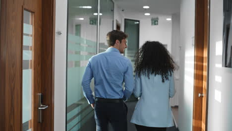 Creative digital devices people going at office. Colleagues talking in corridor