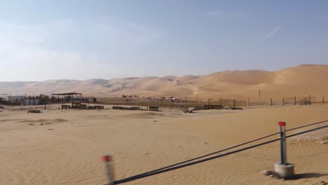 incredible view driving through amazing abu dhabi sand dunes in desert on hot day