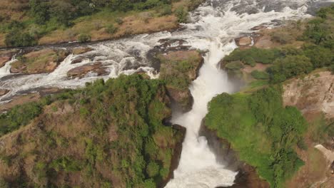 aerial drone shot of the path of a river and its final waterfall