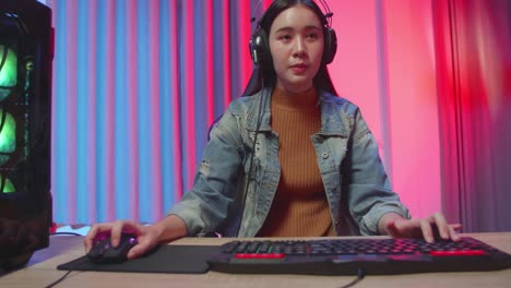 girl gamer playing video game on computer