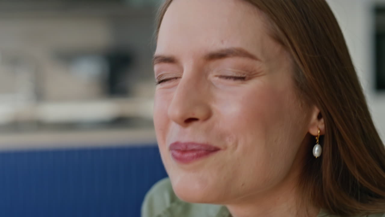 Happy woman biting chocolate closing eyes with satisfied expression closeup