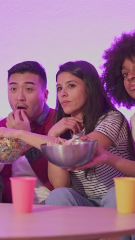 friends enjoying snacks during a movie night