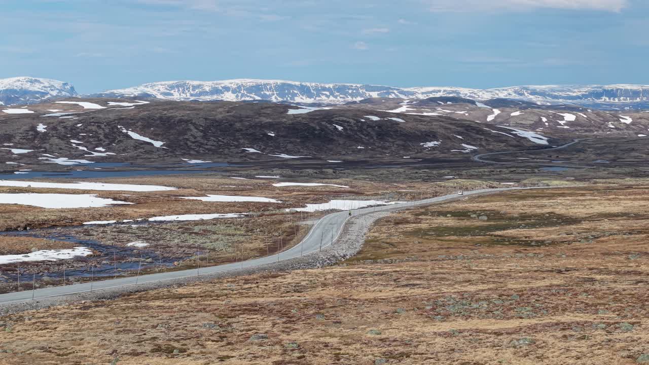 Cars Driving In The Norwegian National Road 7 Along Hardangervidda Plateau In Norway. - aerial shot