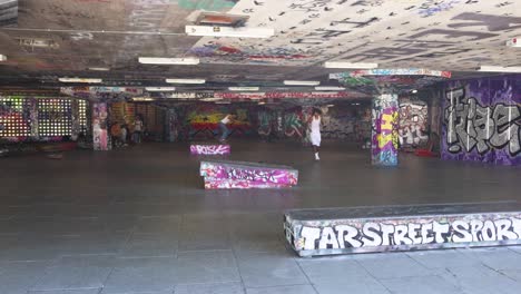 skateboarder performing tricks in urban skatepark