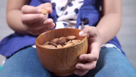 child eating almonds