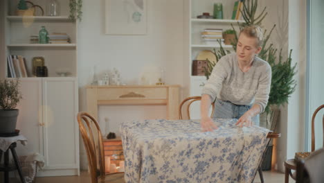 Frau-Legt-Tischdecke-Auf,-Während-Sie-Den-Tisch-Deckt