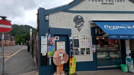 people walking by a fudge shop in llangollen