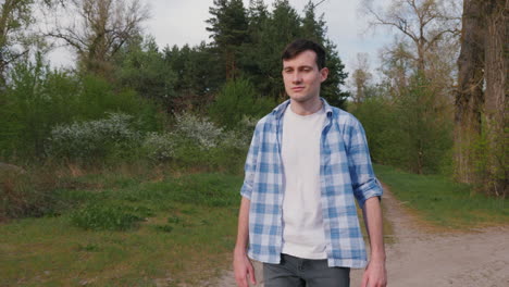 man walking on a path in a spring forest