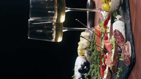 charcuterie board with wine glasses