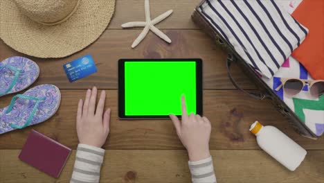 aerial footage of woman using tablet computer by beach supplies