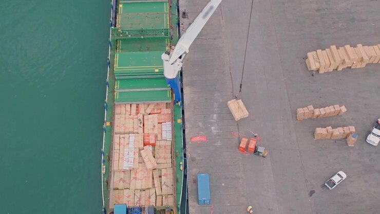 Aerial view overlooking a ship unloading crates to the Port, in sunny Dominican Republic