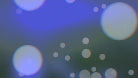 caída de grandes brillos redondos y partículas sobre fondo azul y de moda