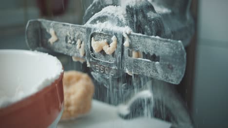 old traditional mill for cookie dough is covered with flour