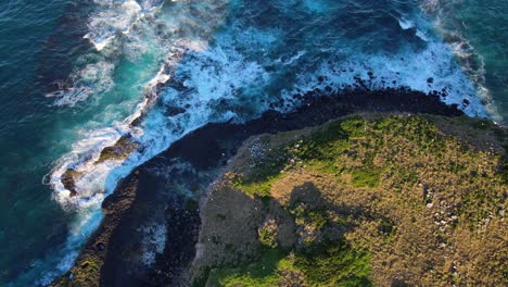 big waves from the pacific ocean beating the rocky coastline of cook island