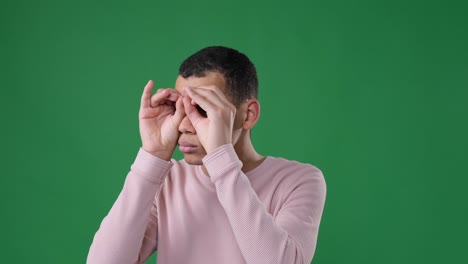 man searching with handmade binoculars