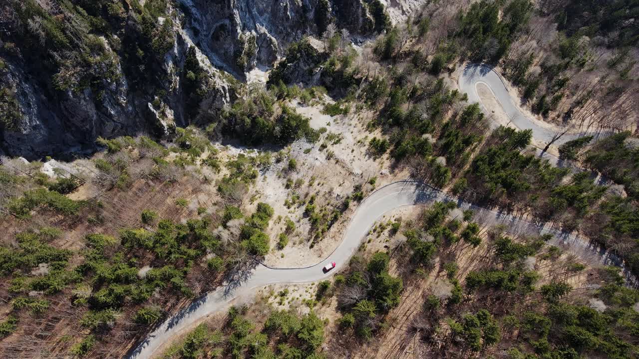 High aerial view of car on winding roads through scenic Triglav mountain park