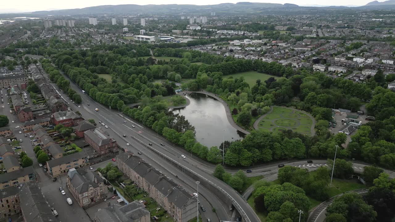 Wide aerial pullback of Victoria Park environment, Glasgow West End, Glasgow, Scotland, UK