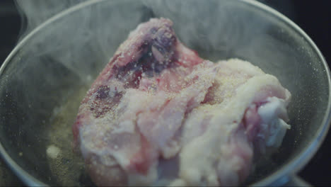raw chicken in a frying pan