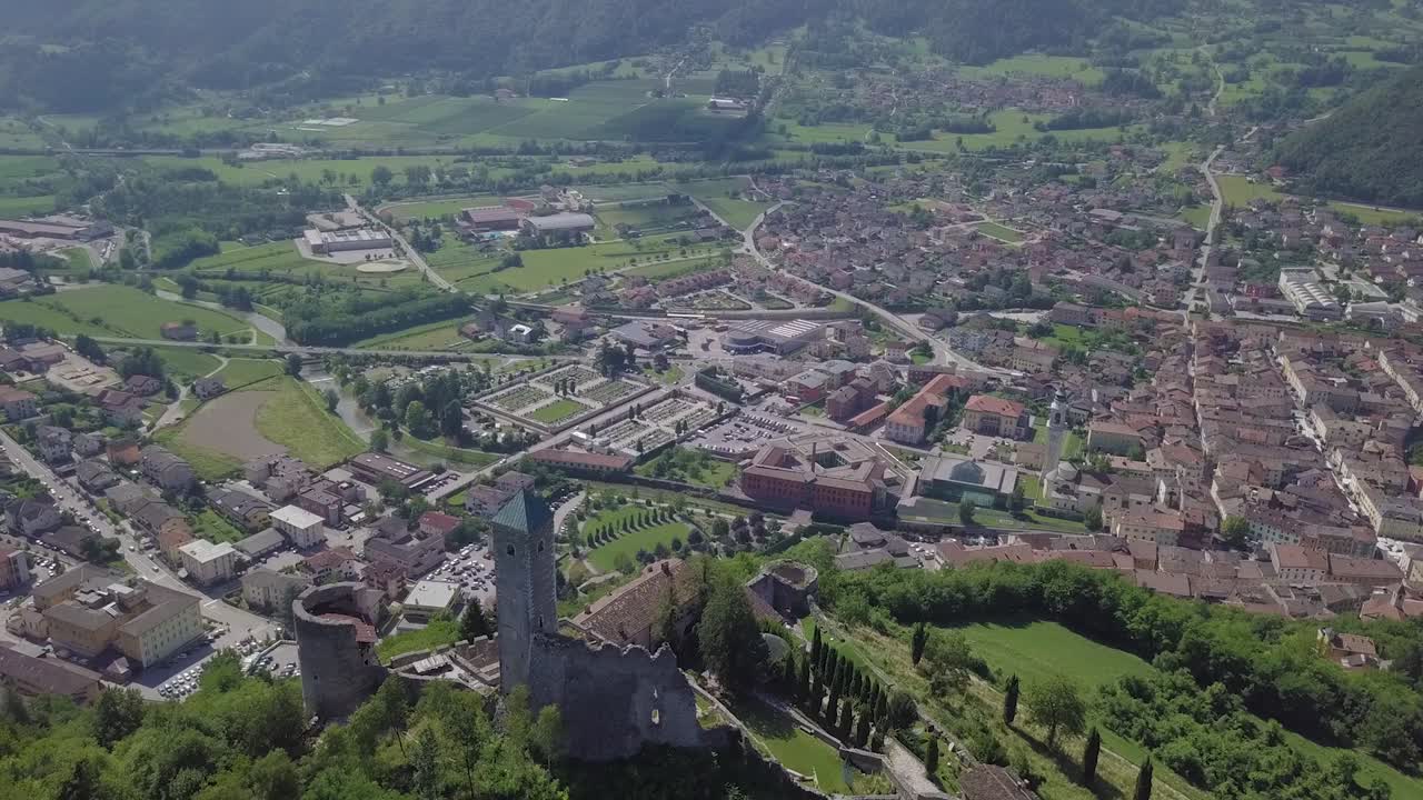 이탈리아 트렌티노(trentino italy)의 보르고 발수가나(borgo valsugana)의 탁 트인 전망, 도시와 산의 전망, 뒤로 날아가는 드론