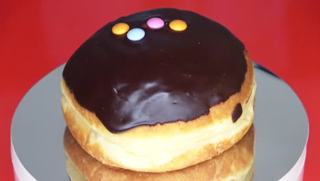 loopable close-up of a spinning berliner with chocolate coating.