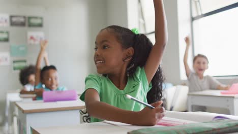 Video-of-happy-african-american-girl-raising-hand-during-lesson