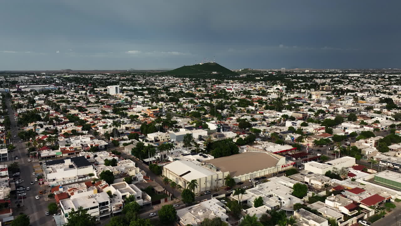 Drone flyover the streets of Los Mochis city, sunny day in Sinaloa, Mexico