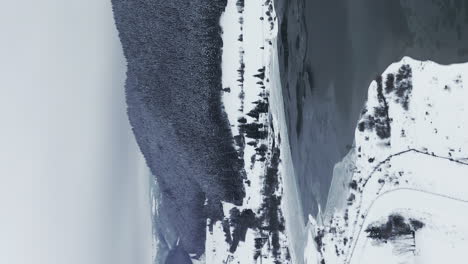 view of frumoasa dam in romania during winter - vertical video for social media stories