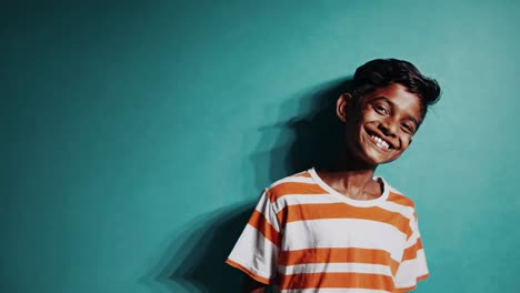 smiling boy in orange striped shirt