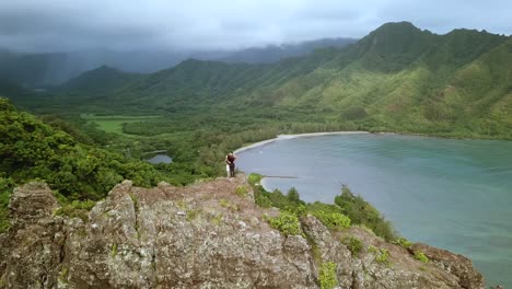 Drohnenaufnahme,-Die-Ein-Romantisches-Paar-Umkreist,-Das-Sich-Oben-Auf-Den-Klippen-Auf-Der-Kauernden-Löwenwanderung-Auf-Oahu,-Hawaii,-Küsst