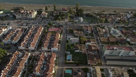 explore the charm of malaga, spain, with our captivating drone footage capturing rincon house nestled among houses with red roofs, offering stunning sea views beyond the coastal road