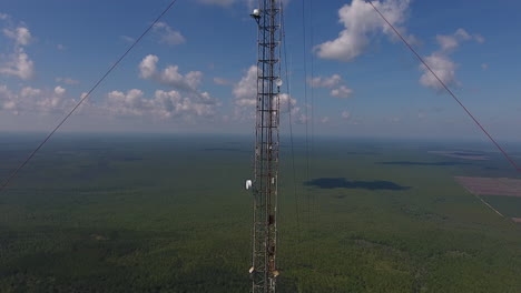 drone shot moving away from a communication tower