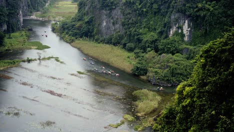 aerial view of people on boats in a scenic river valley