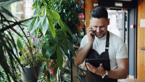florist talking on phone and using tablet