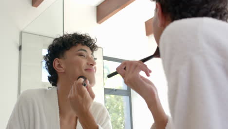 applying makeup, non binary person smiling in mirror at home, feeling confident