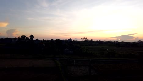 yellow, pink blue sky, rising sun bali indonesia sky backlit rice fields morning magical time lapse