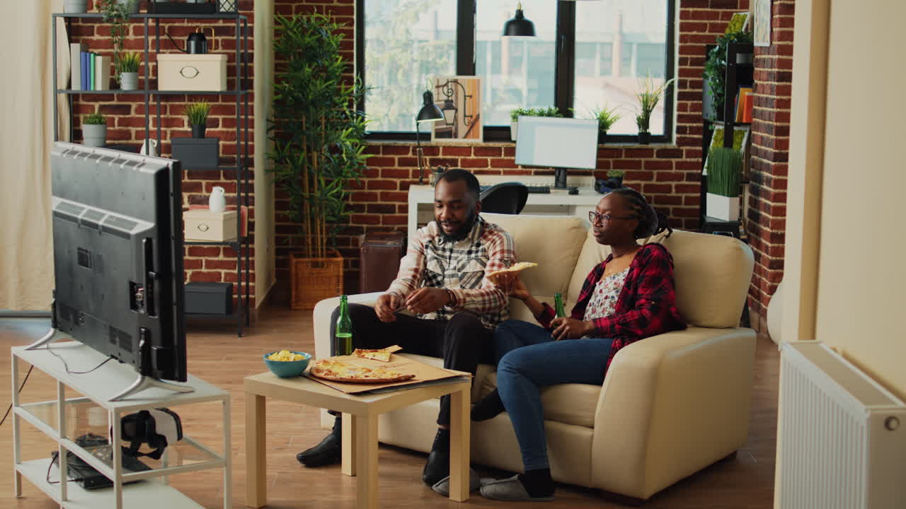 African american people eating slices of pizza