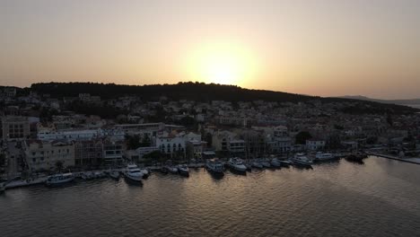 cinematic aerial of city argostoli on island kefalonia in greece in warm sunset