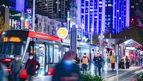 time lapse of passengers arriving and leaving on the tram at circular quay sydney during vivid festival 2022