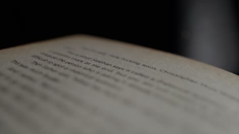 close up through an open book page with out of focus words