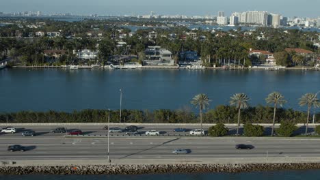 view of water and traffic and palm trees in south beach miami