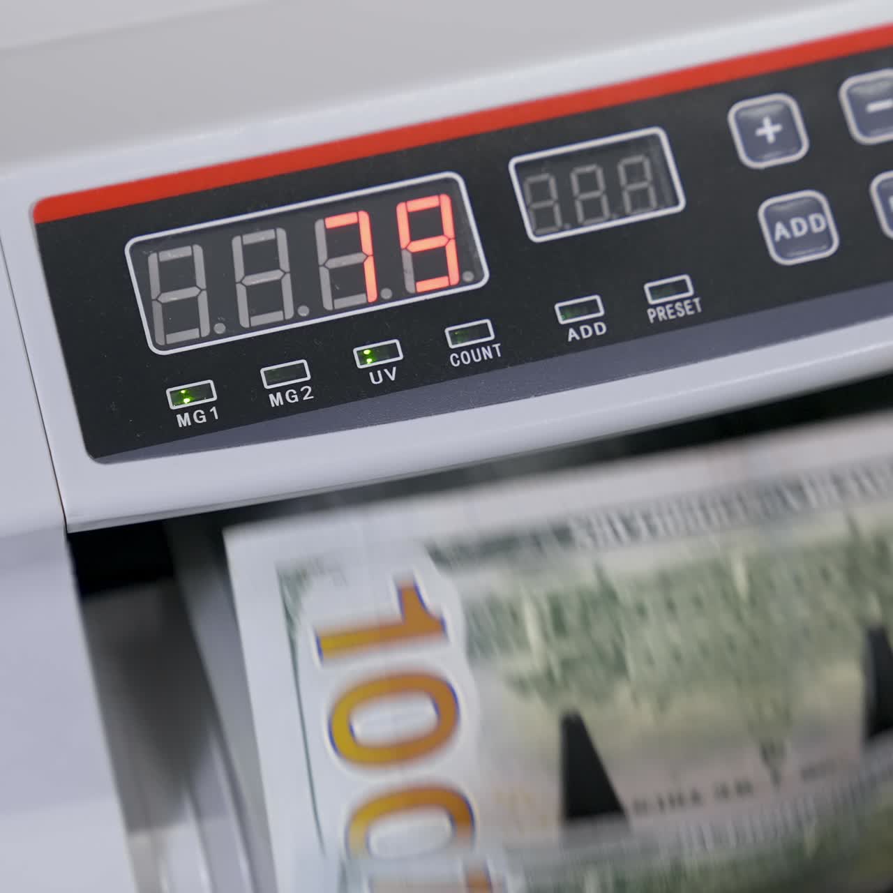 Cash money counting machine. Banknote counter are counting hundred dollar bills. Close-up