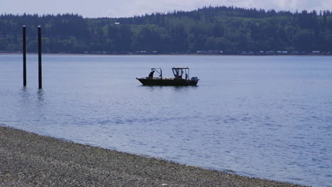 small, nondescript fishing floating near dock at camano island state park, wa state