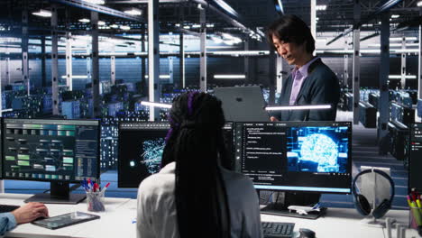 team leader supervising technicians in server room using ai
