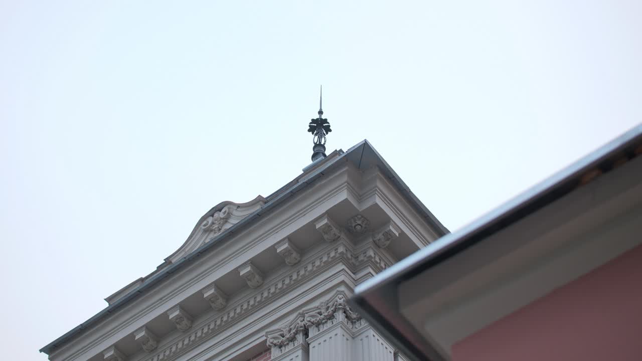 은 파란 하늘 아래 지붕에 첨탑이 있는 우아한 오래된 건물